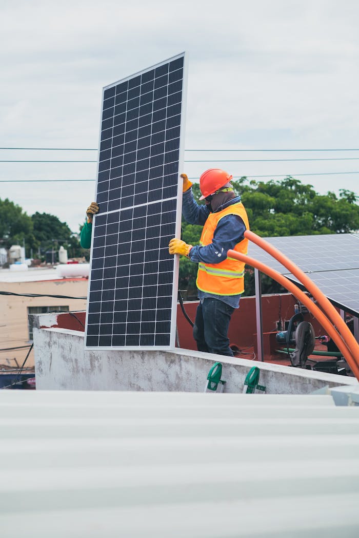 The Art of Drawing Readers In: Your attractive post title goes here A technician in safety gear installs a solar panel on a rooftop, promoting renewable energy.